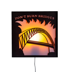 Lit up Don't Burn Bridges sign light from Scotch & Sofa.
